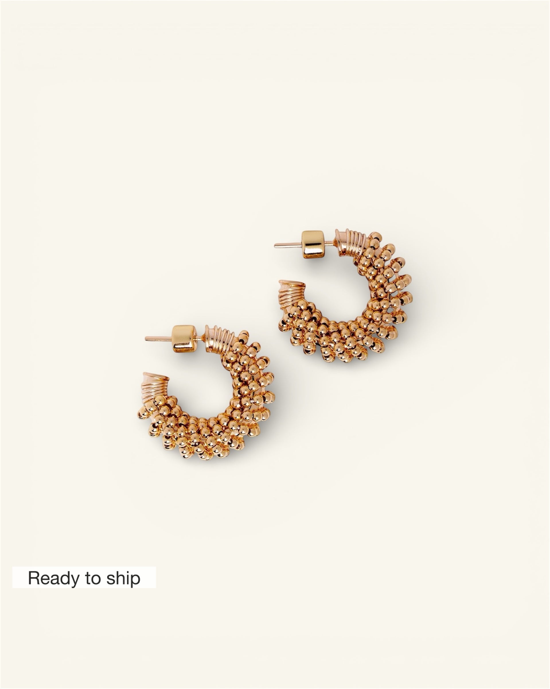Pair of gold hoop earrings on a white background